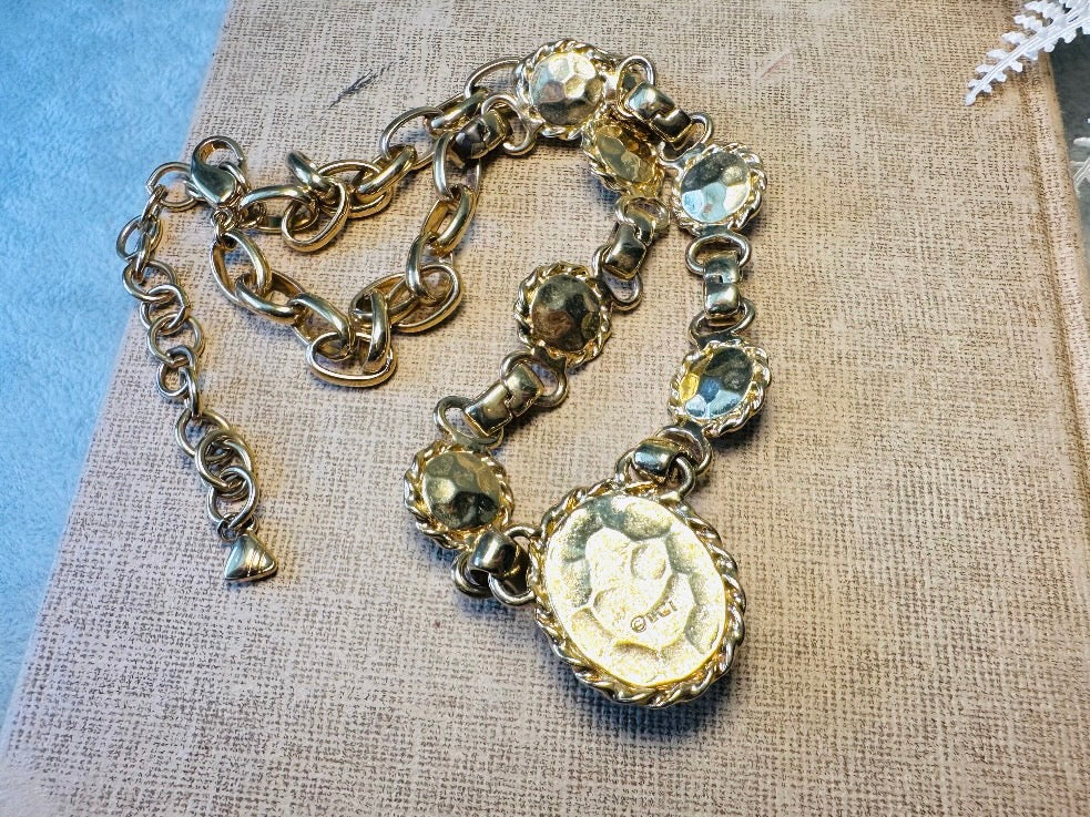 This vintage Etruscan style Liz Claiborne gold chain necklace is a beautifully unique find. Featuring large curb chain links with round cabochons of faux hematite and bronze set in gold bezels. In the center is a larger bronzed oval cabochon in the same style of gold roped bezel. Signed on back of center cabochon as well as the signature LCI triangle hang tag on the end of extender chain. Versatile while making a statement, and incredibly flattering. Minimal wear from age, no major flaws to note; &nbsp;in g
