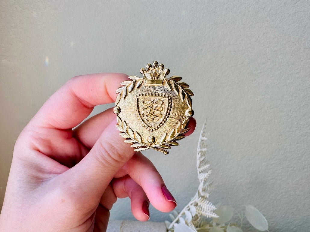 Vintage Gold Shield Brooch, Heraldic Coat of Arms Pin held in hand