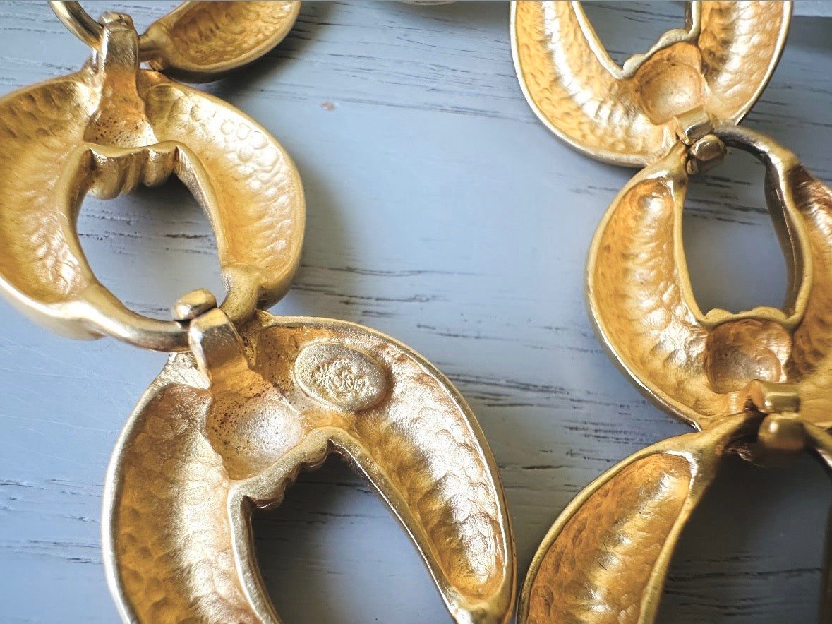 This is a matte gold chain link vintage bracelet by Premier Designs. The links are round and wide with textured ribbing in the center. The finish is a satin matte gold. Very popular style in the 1980s and modern. signed designer stamp.