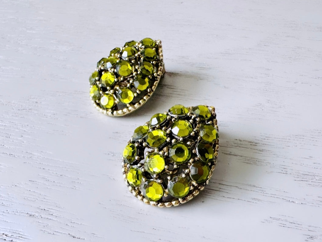 Close up of Vintage Signed Weiss Olivine Green Teardrop Rhinestone Earrings from Piggle and Pop