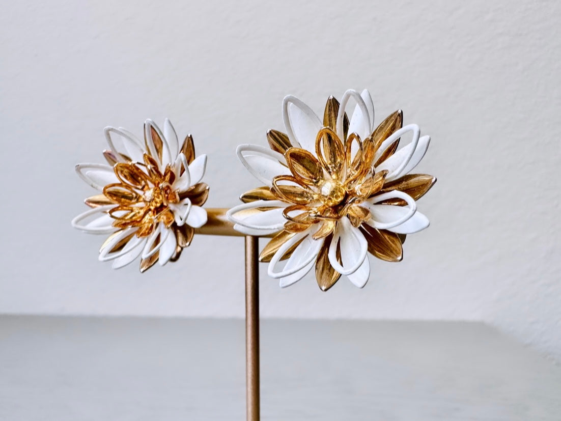 Close up of White and Gold 1966 Vintage Water Lily Clip On Earrings by Sarah Coventry