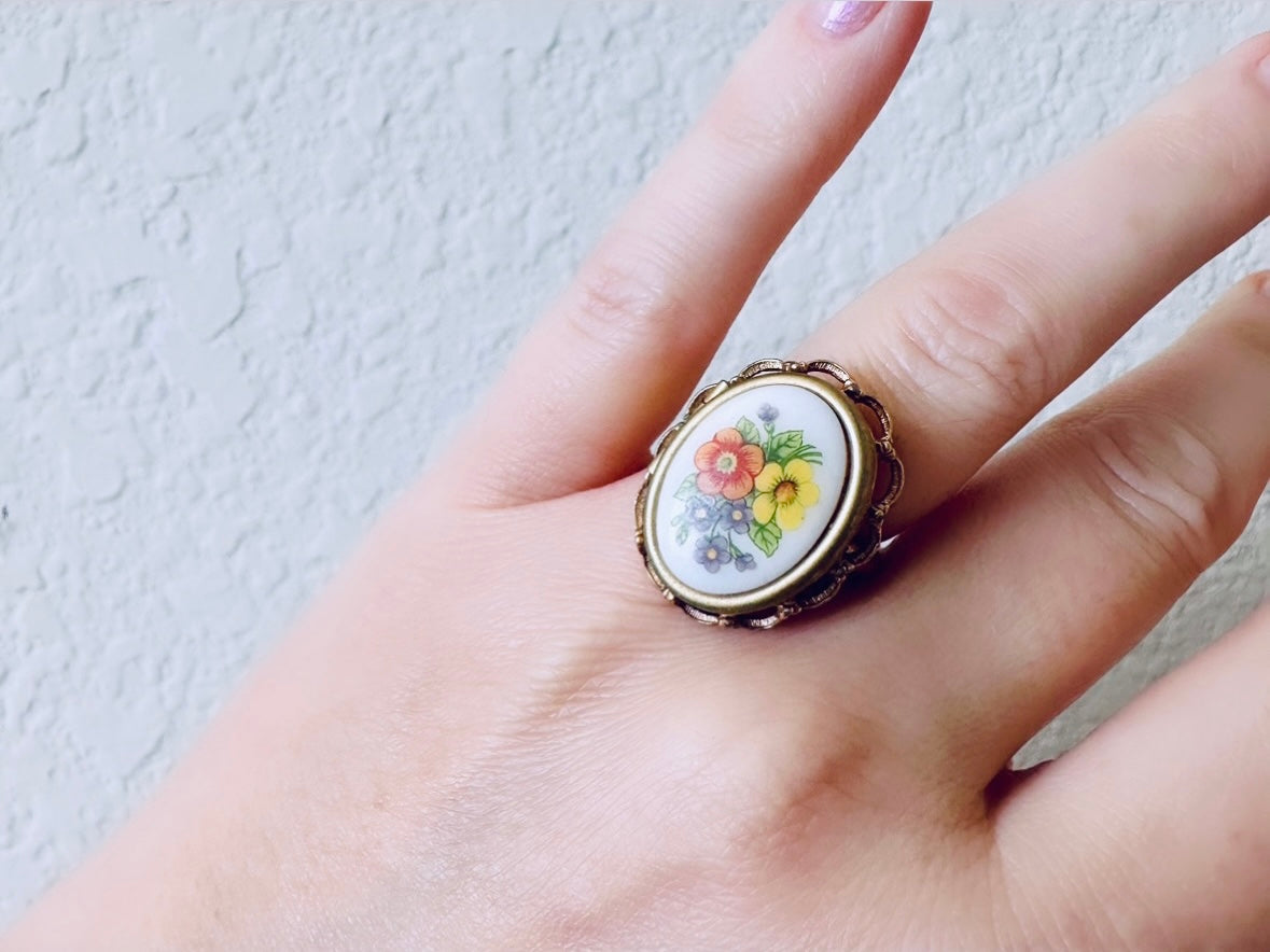 Floral Locket Ring, 1975 Vintage Avon Ring, Whimsical White Porcelain Cameo with Colorful French Flowers, Gold Tone 70s Adjustable Ring