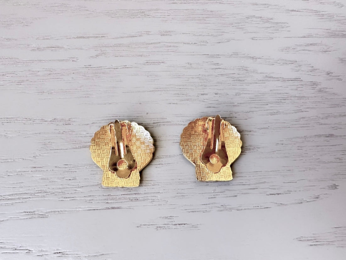 the backs of Vintage black and gold enamel clip on shell earrings from Piggle and Pop